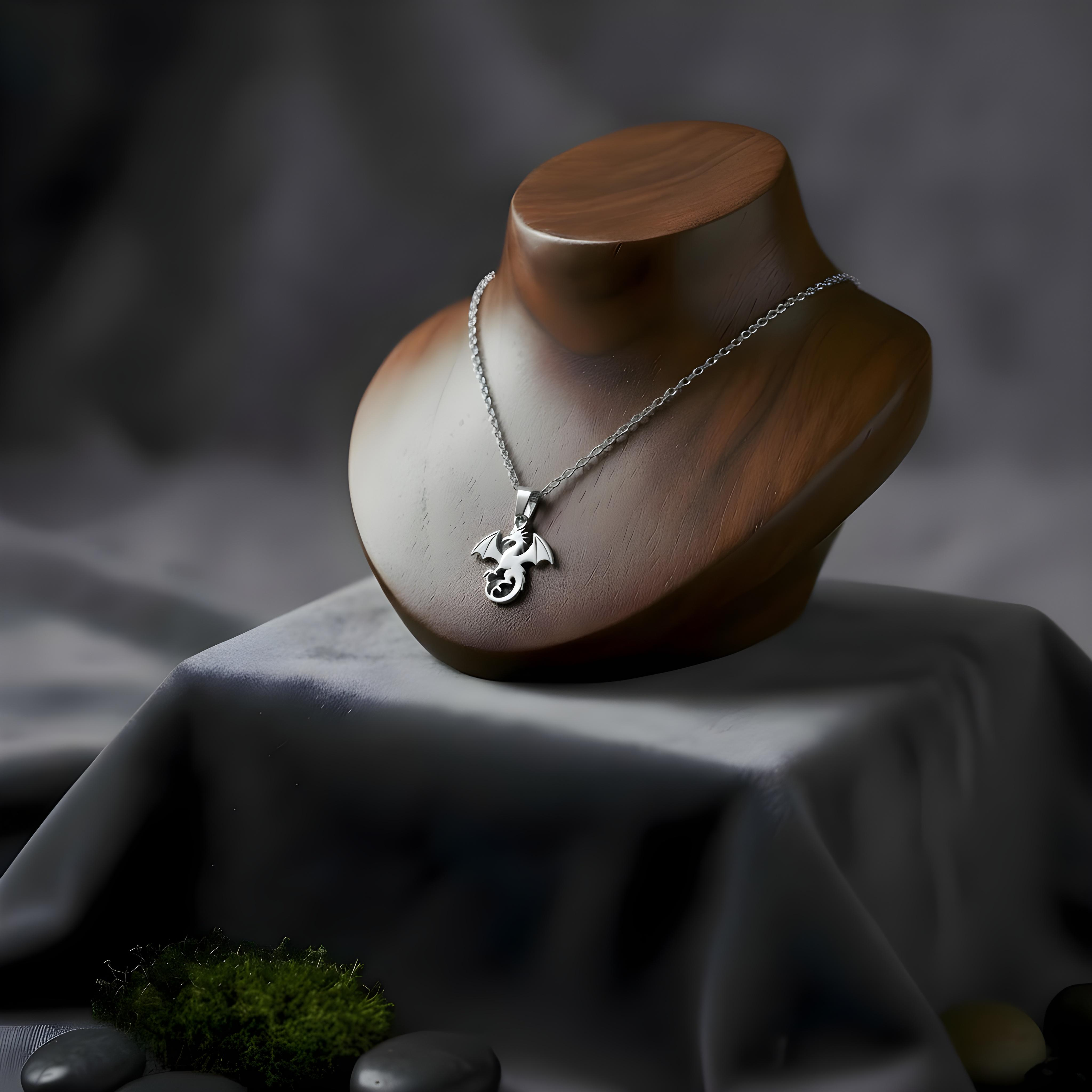 Silver necklace with a pendant on a wooden mannequin head against a dark background