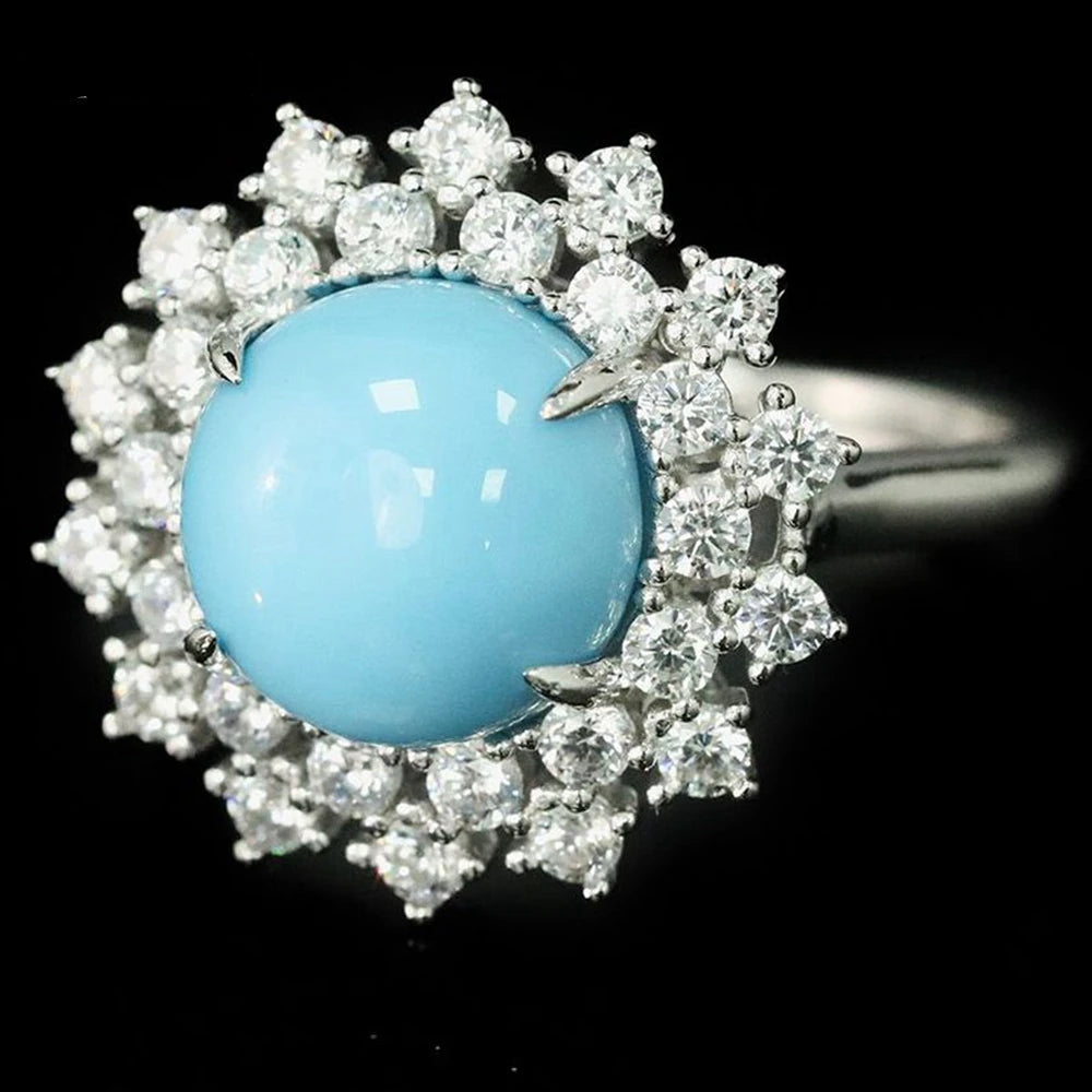 Ring with blue gemstone and diamond-like stones on a black background