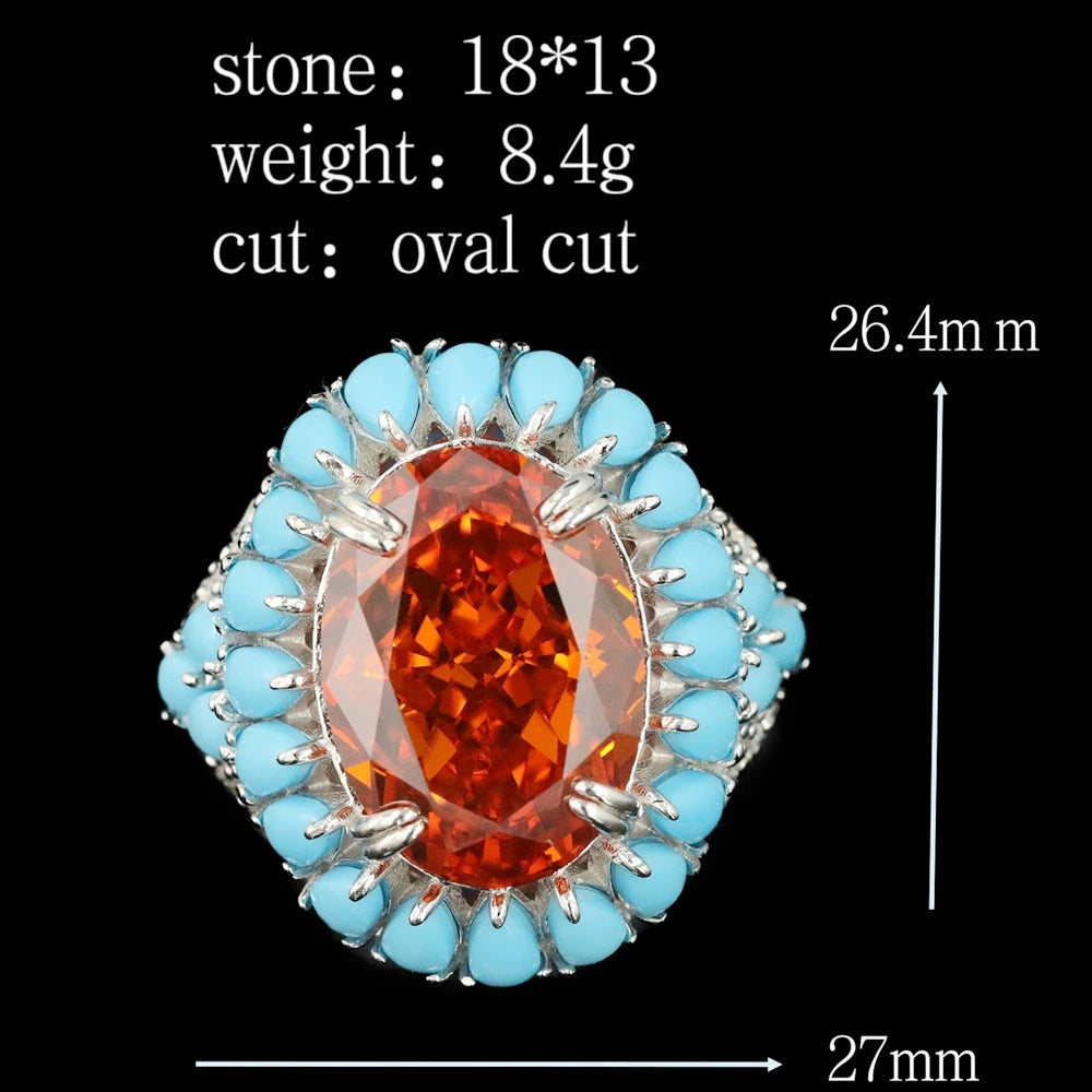 Jewelry with an orange gemstone and turquoise accents on a black background