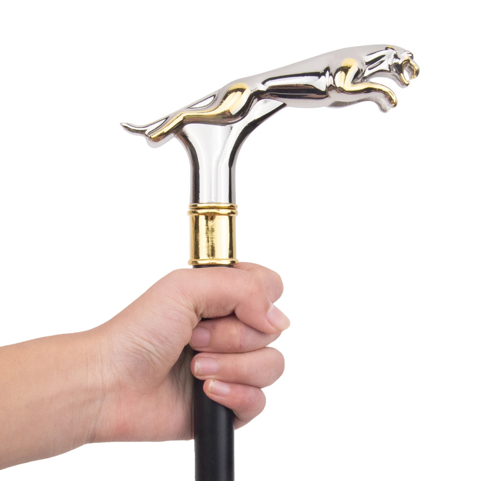 Cane handle with a silver and gold panther design held by a hand on a white background.