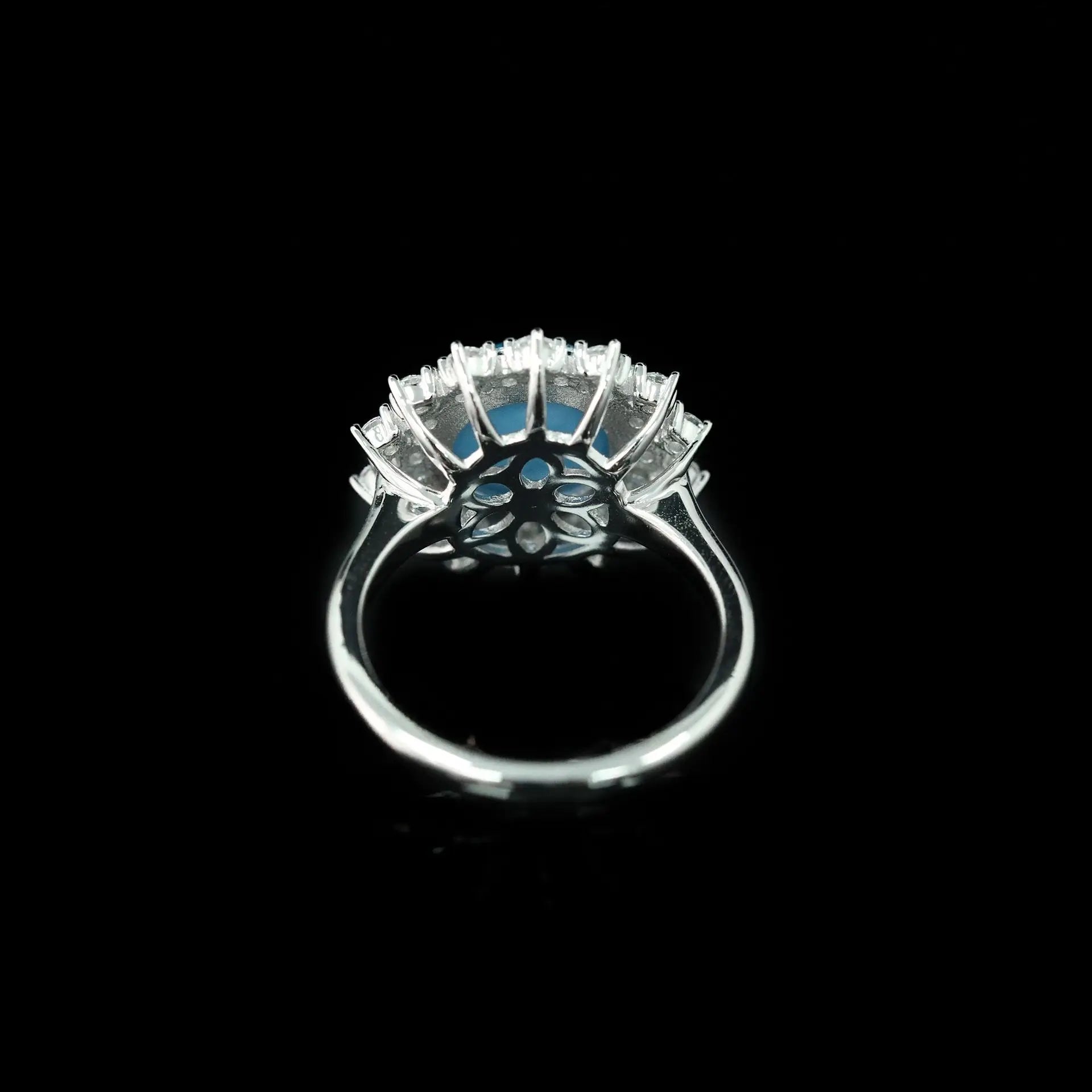 Silver ring with blue gemstones on a black background