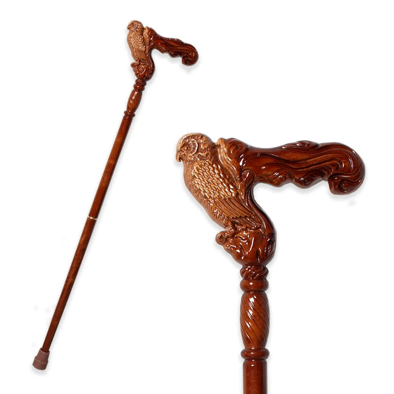 Wooden walking cane with detailed bird carvings on a white background