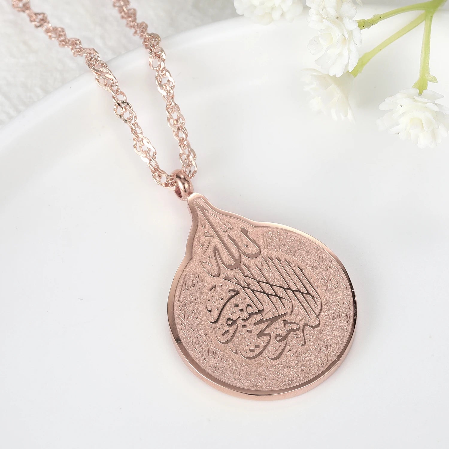 Rose gold necklace with a pendant on a white background