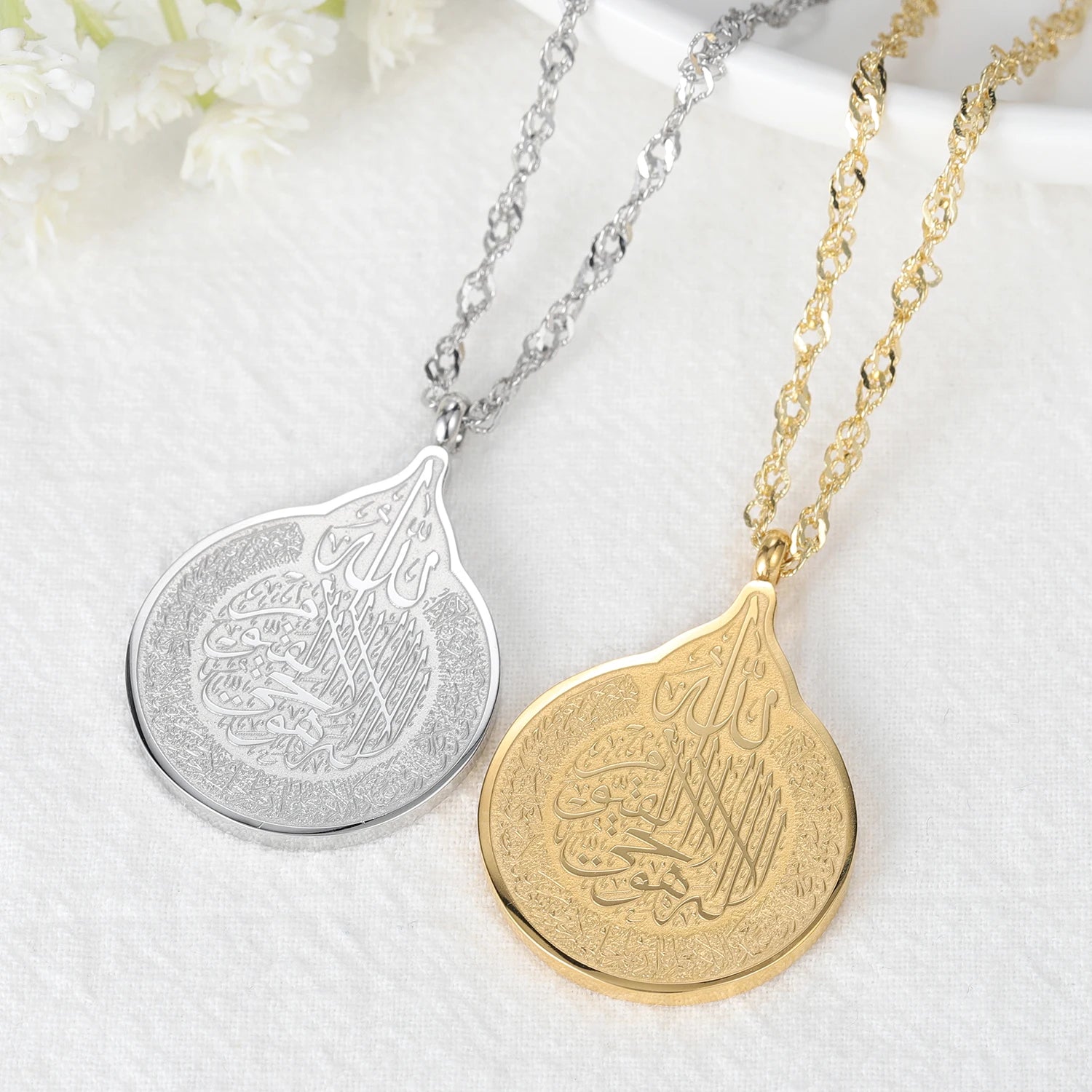 Two necklaces with teardrop-shaped pendants on a white background