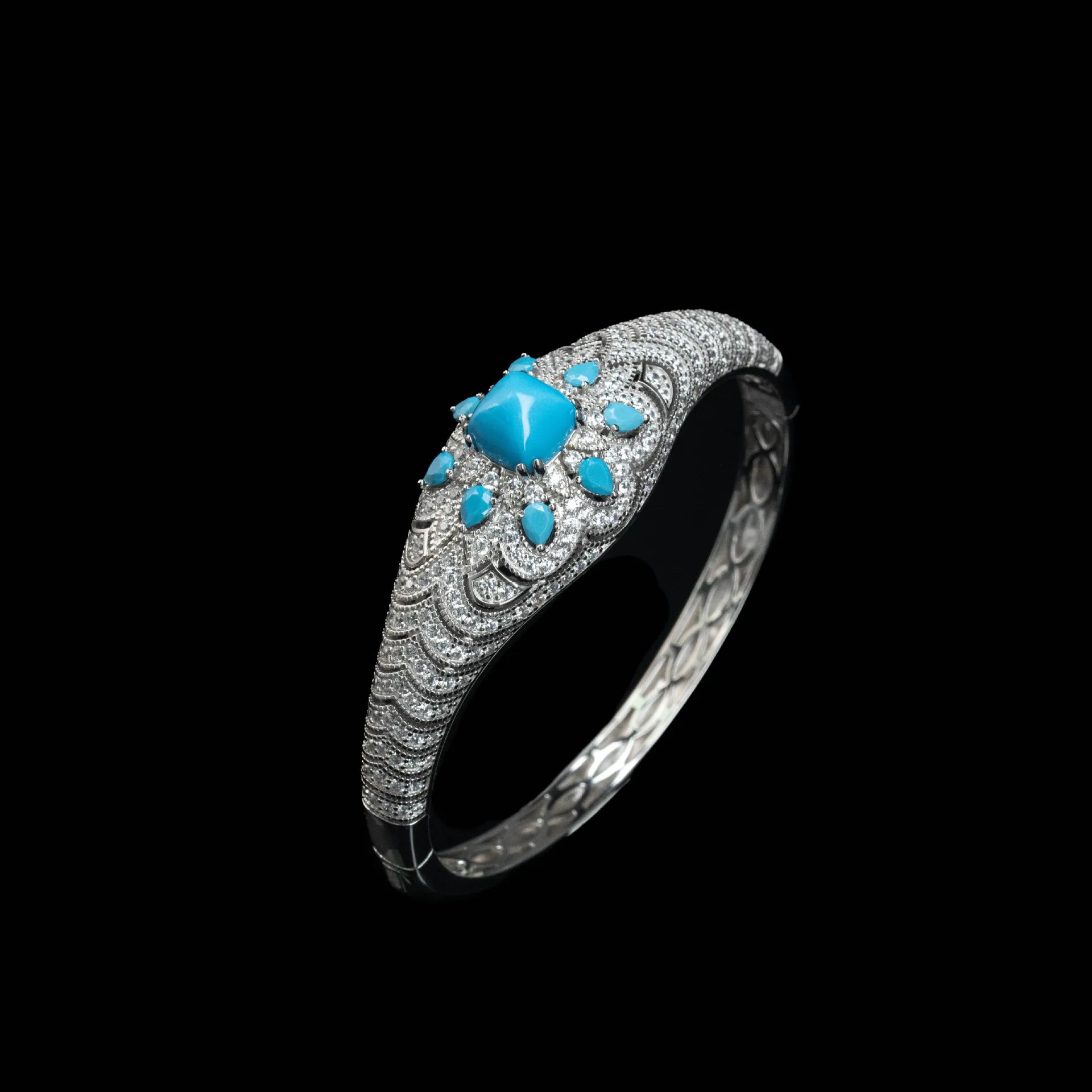 Silver bracelet with turquoise stones on a black background