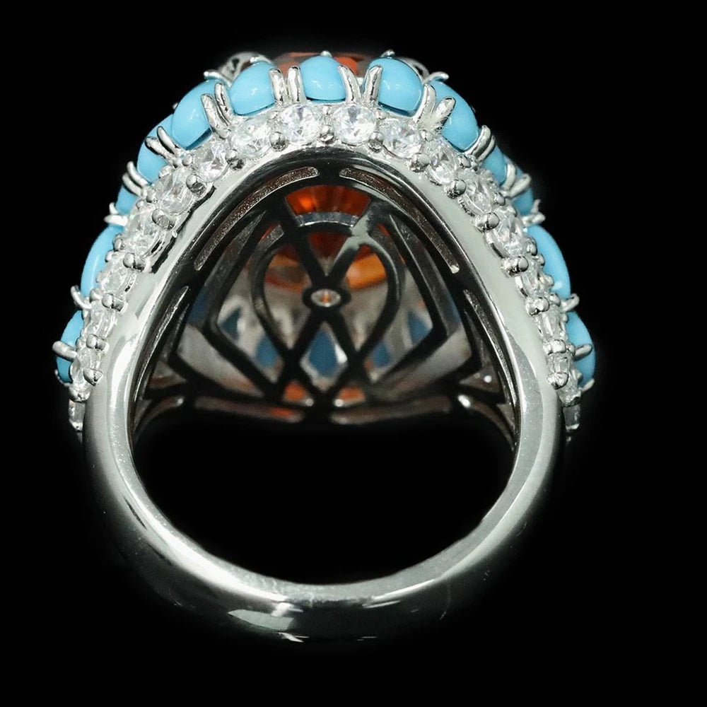 Ring with turquoise stones and diamonds on a black background