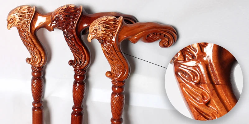 Wooden walking sticks with detailed eagle carvings on a white background