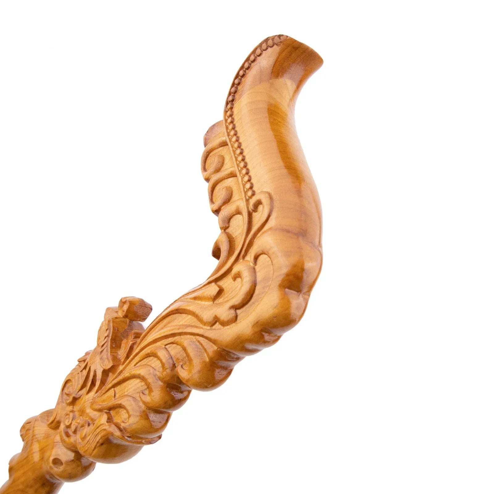Wooden cane handle with intricate carvings on a white background