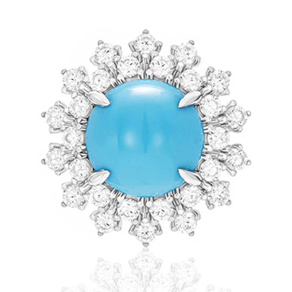 Jewelry item with a blue gemstone surrounded by diamonds on a white background